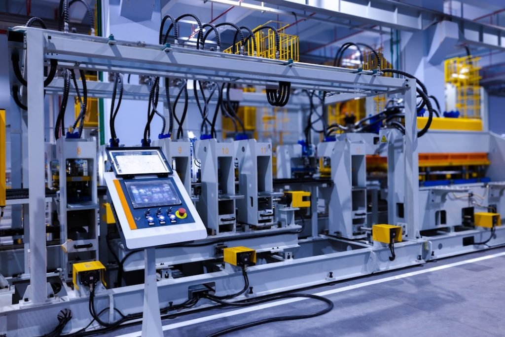 A view of the refrigerator manufacturing plants fully automated side panel forming line.Translation: Warning:Danger Prohibit reach into;elecric shock;must connect an earth terminal to the ground